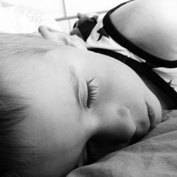 Close-up of boy sleeping on bed at home