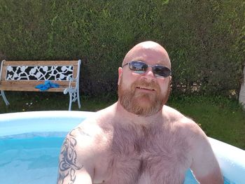 Portrait of smiling young man in swimming pool