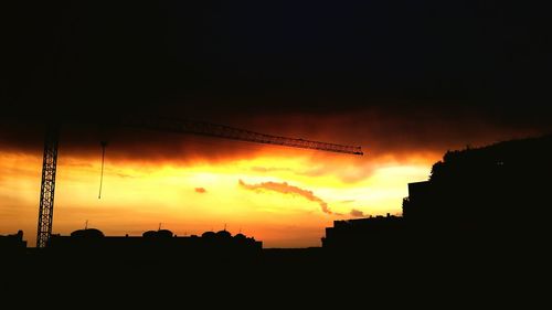 Low angle view of silhouette building against sky at sunset