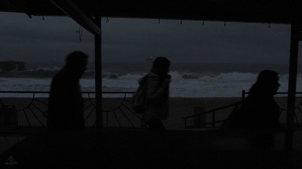 darkness, silhouette, light, black, sea, water, group of people, sky, women, nature, men, white, adult, small group of people, beach, lifestyles, leisure activity, night, evening, transportation, black and white, sitting, monochrome, land, outdoors, shadow, architecture, standing, railing, dark, cloud