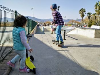 Rear view of people skateboarding on skateboard