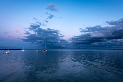 Sailboat in sea against blue sky