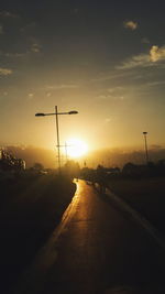 Car on road against sky during sunset