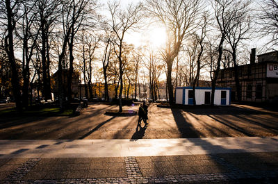 Man walking on street amidst buildings in city