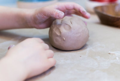 The child works with clay. the concept of a creative workshop for a child.