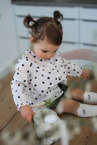 Portrait of cute girl playing with teddy bear