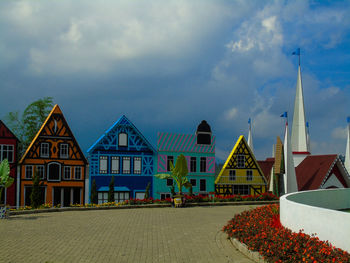 Buildings against cloudy sky