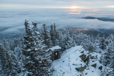 Outhouse in snow at sunrise on squaw mountain, colorado