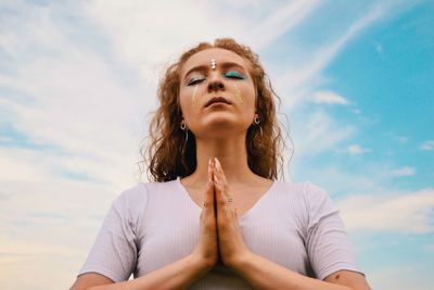 Low angle view of woman against sky