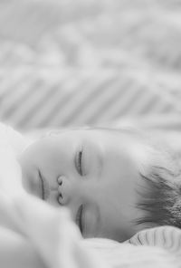 Close-up of woman sleeping on bed