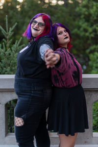 Portrait of young women leaning on each other