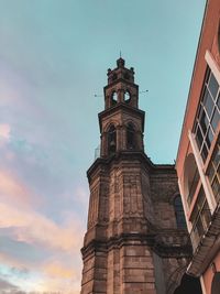 Low angle view of clock tower against sky