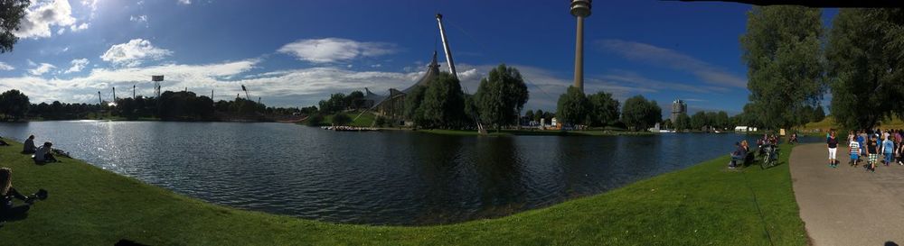 Panoramic view of people on river against sky