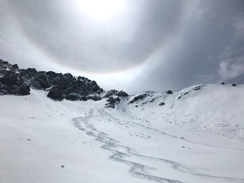 Scenic view of snow covered mountains against sky