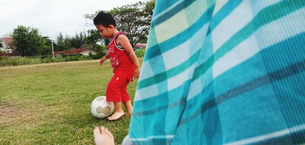 Full length of boy playing with ball