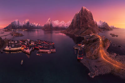 Aerial landscape of calm river and rocky formations located in hamnoy under sunset sky in evening