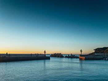 Scenic view of sea against clear sky during sunset