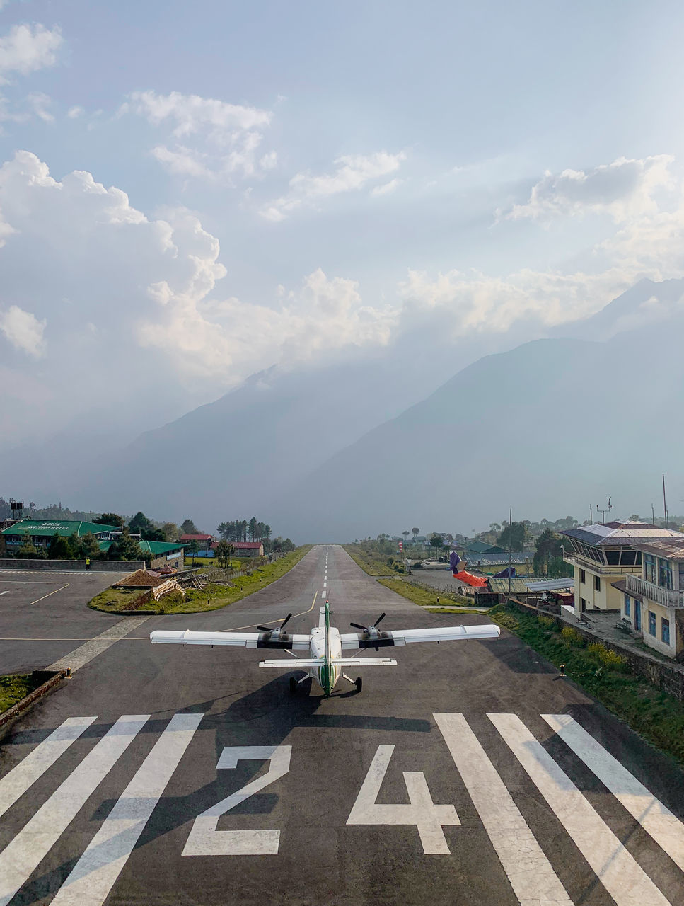 VIEW OF AIRPORT AGAINST CLOUDY SKY