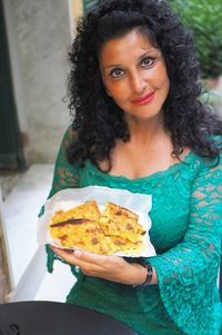 Portrait of woman holding food in plate