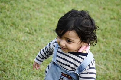 High angle view of cute baby girl standing on land