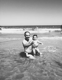 Rear view of man standing on beach