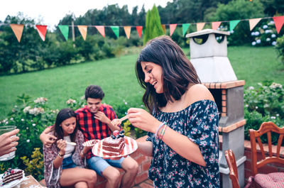 Friends having leisure time together at backyard