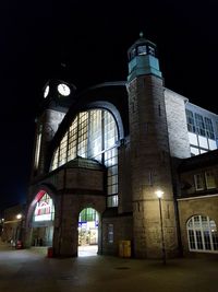 Low angle view of illuminated building against sky at night