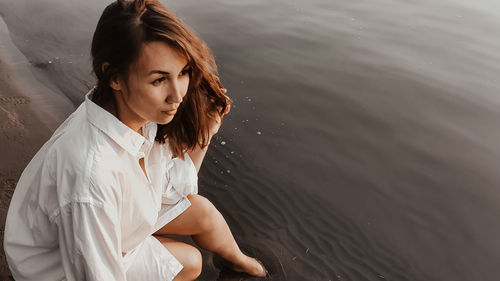 High angle view of woman sitting in lake