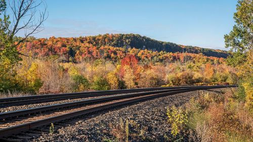 Railroad tracks against sky during autumn