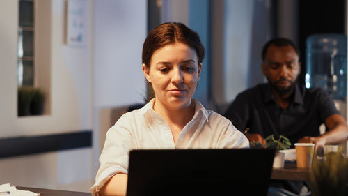 Young woman using laptop at office