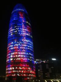 Low angle view of illuminated buildings at night