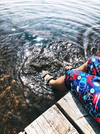 High angle view of woman relaxing by lake