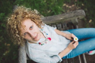 Portrait of woman sitting on bench