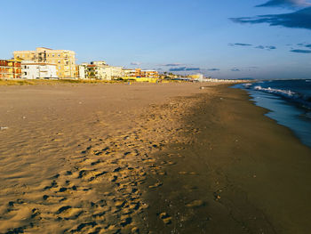 View of calm beach against blue sky