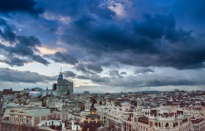 Buildings against cloudy sky