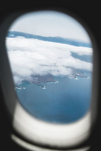 Aerial view of sea seen through airplane window