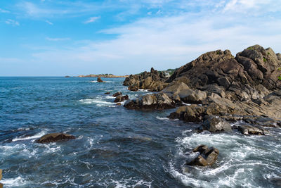 Rock formation on sea against sky