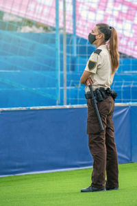 Full length of security officer standing at stadium