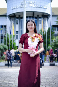 Portrait of young woman holding gift