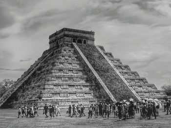 Tourists walking by el castillo against sky