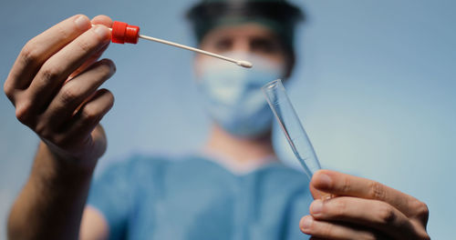 Young nurse prepares tube tube for covid swab test