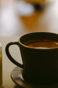 Close-up of coffee cup on table