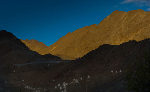 Scenic view of desert against clear blue sky