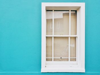 Closed window on blue building