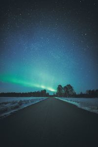 Road against sky at night