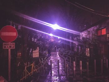 Illuminated walkway at night