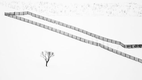 Low angle view of cranes against sky during winter