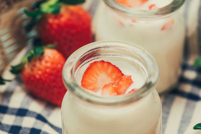 Close-up of strawberry in glass jar on table