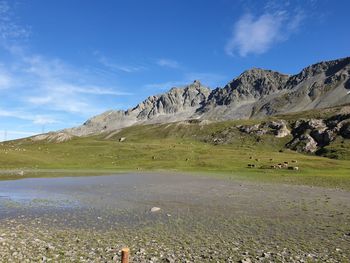 Scenic view of landscape and mountains against sky