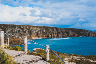 Scenic view of sea and mountains against sky